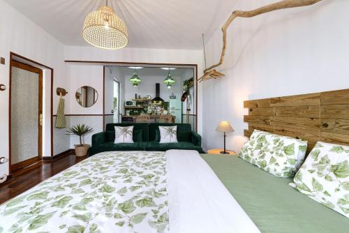 a bedroom with a large bed and a green couch at Zamudio Cozy Room By Next Stop Bilbao in Zamudio