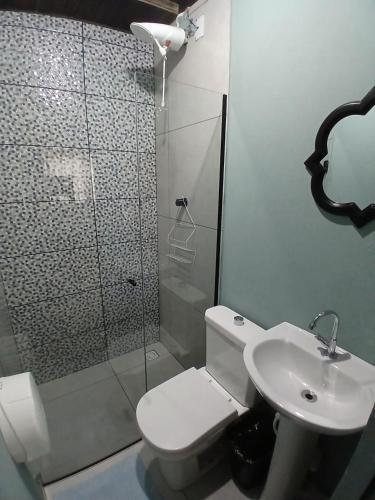 a bathroom with a shower and a toilet and a sink at Maga Inn House - Centro in Blumenau