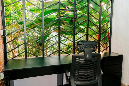 a desk with a chair in front of a window at Ndare Eco Ville in Kigali