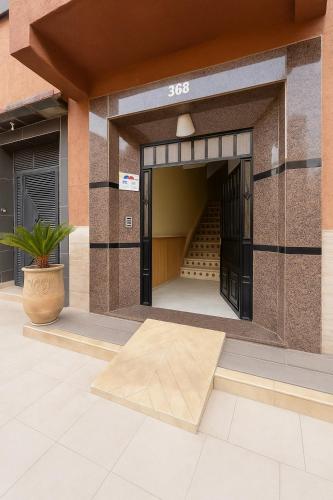 a building with an open door with a staircase at SABOR FAMILY APARTS -Jaouharat Al Atlas in Marrakech
