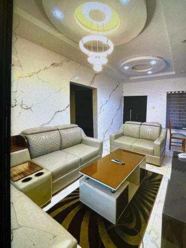 a living room with couches and a coffee table at Dearest service appointments in Lagos