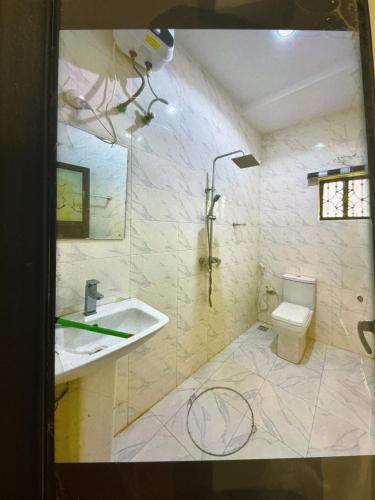 a bathroom with a sink and a toilet at Dearest service appointments in Lagos