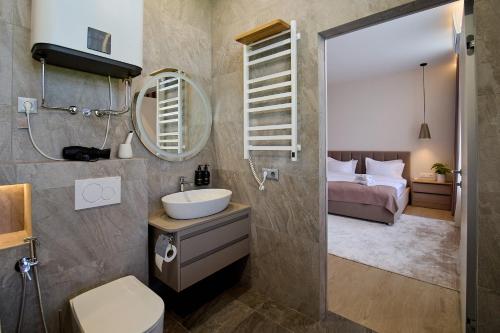 a bathroom with a sink and a toilet and a bed at Forest Retreat Center in Kyiv