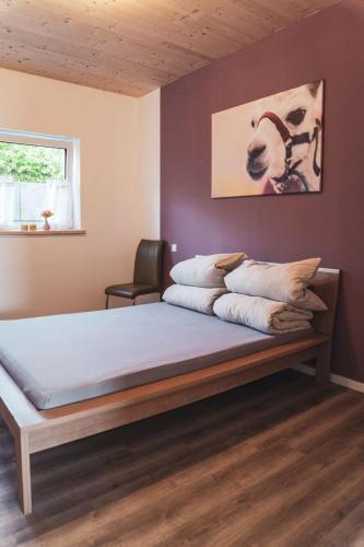 a bedroom with a large bed in a room at Ferienwohnung Sternenzelt Alpakas - Natur & Tiere hautnah erleben in Borken