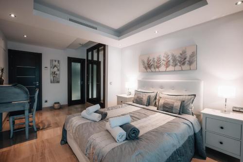 a bedroom with a large bed with blue pillows at Luxury 2 bedrooms, Private Heated Pool - EHHouse in Estepona