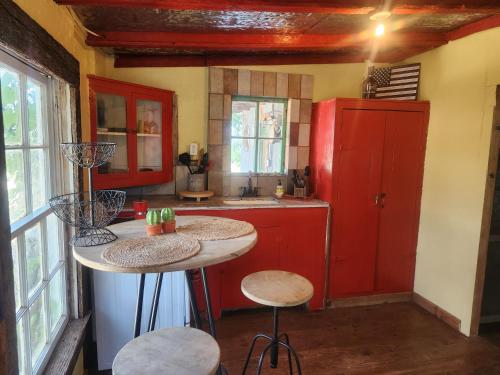 a kitchen with red cabinets and a red refrigerator at Bigfoots Bungalow in Bandera