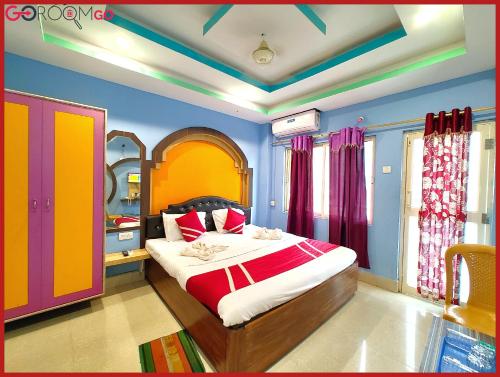 a bedroom with a bed with colorful walls and windows at HOTEL SHRI # BHUMI Near Sea Beach AND Jagannath Temple - Free Wifi & Parking Facilities - Fully Air conditioned & Spacious Rooms - A Luxuary Hotel In Puri in Puri