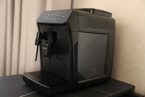 a black coffee maker sitting on top of a table at Hotel France in Vinnytsya