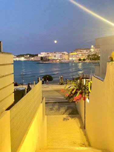 a view of the ocean from a balcony of a building at Blue Adventure in Torre dell'Orso