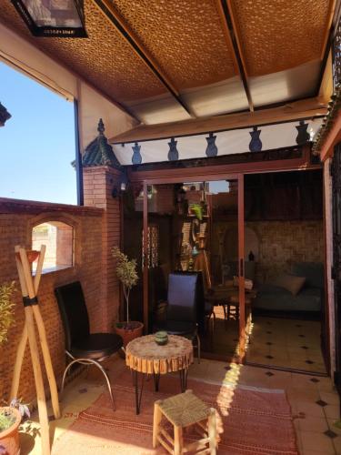 a living room with a table and chairs and a couch at Riad Hostel ADI in Marrakech