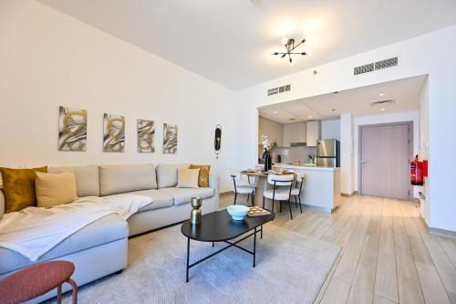a living room with a couch and a table at Chic Family 2br, Canal Views! Near Ferrari World in Abu Dhabi