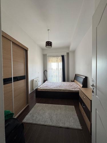 a small bedroom with a bed and a window at Prishtina Capital Center in Pristina
