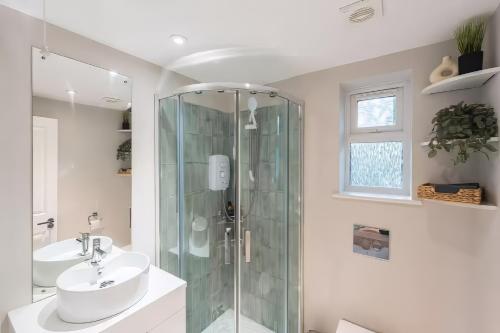 a bathroom with a glass shower and a sink at Studio near Bristol w/ garden & parking in Flax Bourton