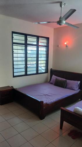 a large bed in a room with a window at Serena Beach Road Apartment in Mombasa