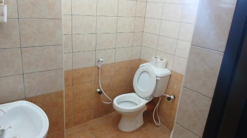 a bathroom with a toilet and a sink at Serena Beach Road Apartment in Mombasa