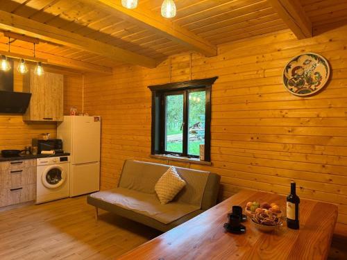 a kitchen with a table and a chair in a room at Садиба Сенчина 