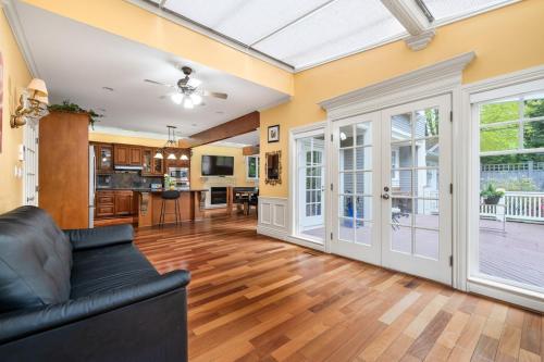 a living room with a couch and a kitchen at Charming Retreat on Cypress St Rooms with share living space in Vancouver