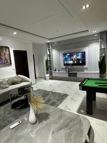 a living room with a pool table and a tv at Luxury 3 Bedroom Apartment Lekki IKATE in Lekki