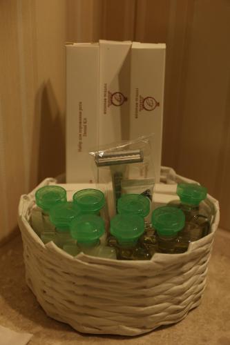 a basket filled with green glass votives next to a box at Hotel France in Vinnytsya