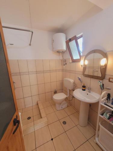 a bathroom with a toilet and a sink at Villa Rruga 6 Velipoje in Velipojë
