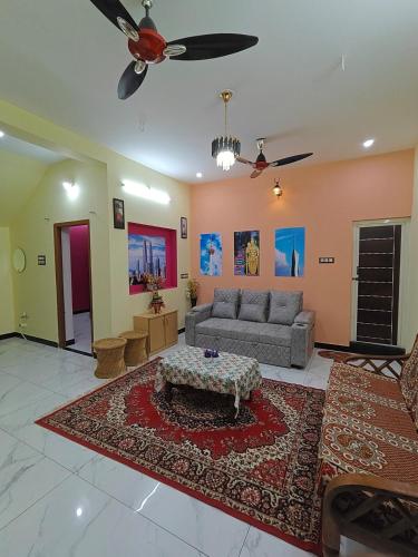 a living room with a couch and a table at KL homestay in Trichy in Tiruchchirāppalli