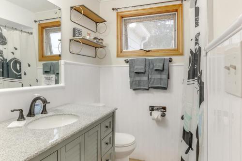 a bathroom with a sink and a toilet and a window at 4 Mi to Main Street! Family Getaway in Zanesville in Zanesville