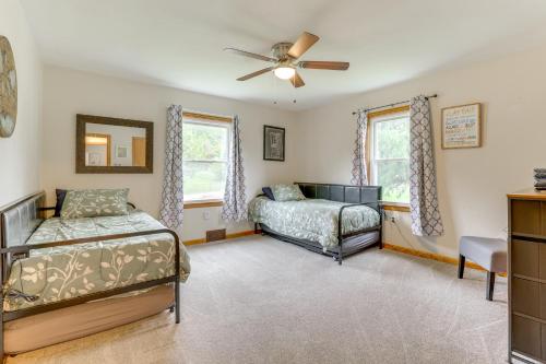 a bedroom with two beds and a ceiling fan at 4 Mi to Main Street! Family Getaway in Zanesville in Zanesville