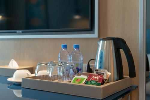a tray with glasses and bottles of water on a table at Rixos Water World Aktau - Theme Park Free Access in Aktau