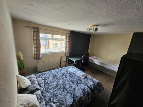a bedroom with a bed and a desk in it at Babo room in Bolton