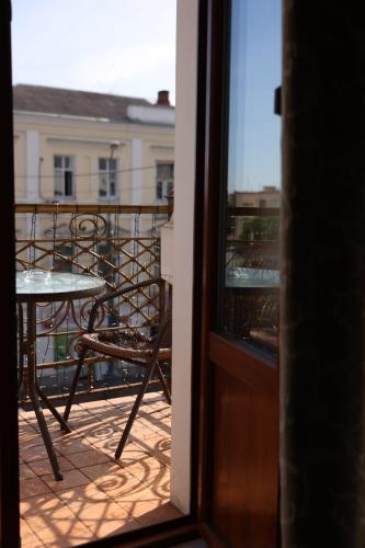 a view of a balcony with a table and chairs at Hotel France in Vinnytsya
