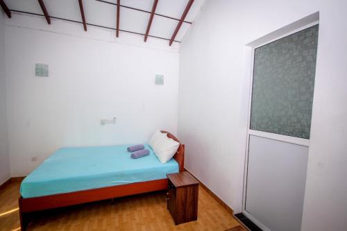 a small room with a bed and a window at Mass Eco Cabana by Ruby in Talpe