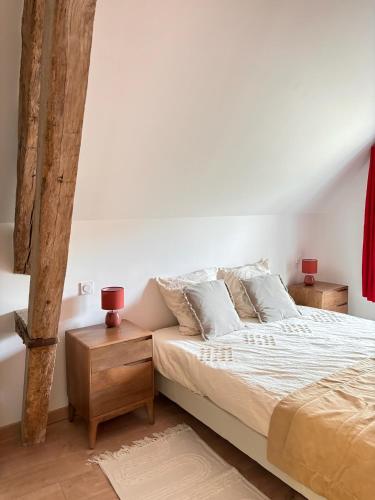a bedroom with a bed and two night stands at Le Domaine d'Ailleurs in Cohan