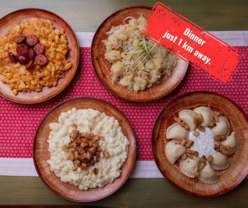 four wooden plates of food on a table at Wellness rezort Jánošíkov dvor in Zázrivá