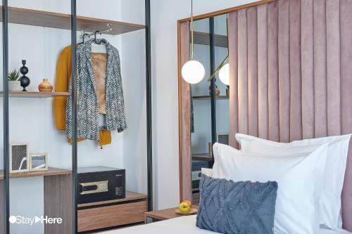 a bedroom with a bed and a mirror at Stayhere Rabat - Agdal 4 - Hotel in Rabat