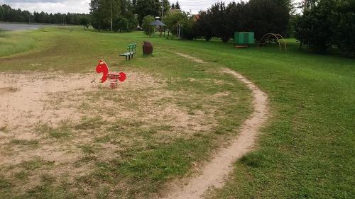 a playground with a red fire hydrant in a field at Paide Homestay in Kriilevälja