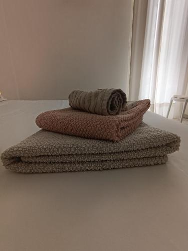 a couple of towels sitting on top of a bed at Casa Morrone Residence in Corato