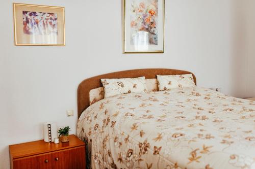 a bedroom with a bed and two pictures on the wall at Ferienwohnungen Krampert in Bad Kissingen