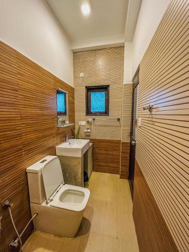 a bathroom with a toilet and a sink at Sunrise Palace Negombo in Negombo