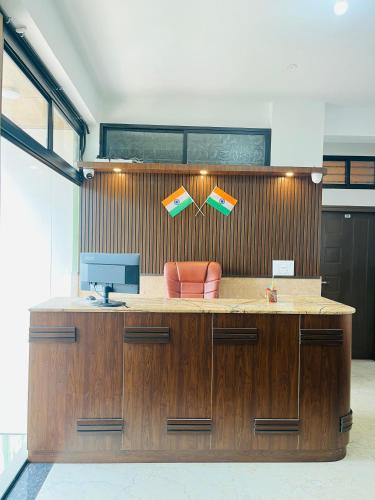 an office with a desk with a computer on it at Nagashree stay inn chickamagalur in Chikmagalūr