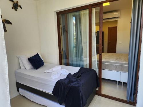 Ένα ή περισσότερα κρεβάτια σε δωμάτιο στο Brisa do Mar loft