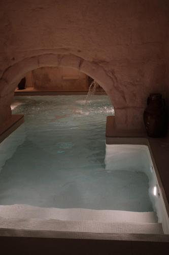 a large pool of water with an arch in a cave at Vecchia Mottola Private Suite & Spa in Mottola