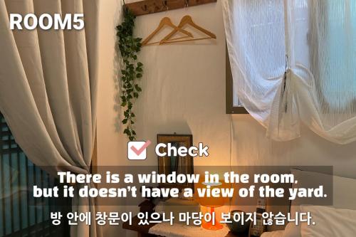 a window in the room with a curtain at Pungnam House in Jeonju