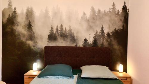 a bedroom with a bed with a forest mural on the wall at Privater Luxus am Untersberg in Grödig