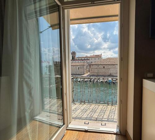 a window with a view of the water at Oreste Suite in Lazise