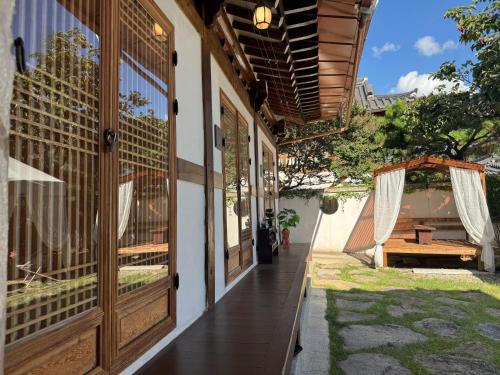 a hallway of a house with a table and a tent at Pungnam House in Jeonju