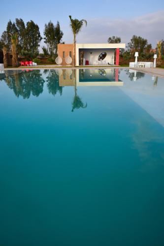 a large swimming pool with blue water at Dar Syada Boutique Hotel Marrakech in Marrakech