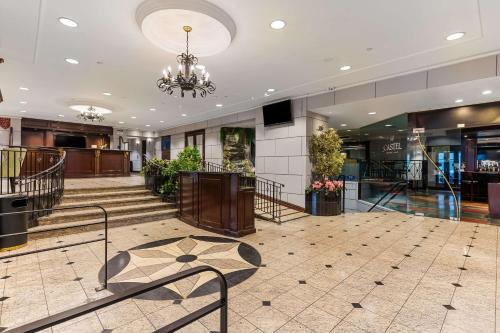 a lobby with a staircase and a chandelier at Best Western Ville-Marie Montreal Hotel & Suites in Montréal