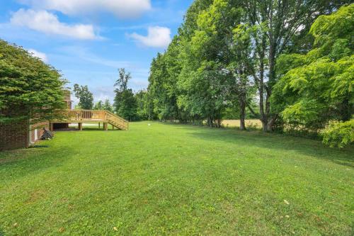 a large grass field with a bridge in a park at Cookeville Family Retreat 3BR Home with Yard Close to TTU & Town in Cookeville