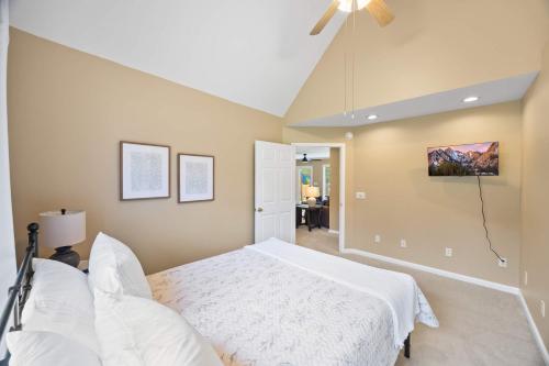 a bedroom with a white bed and a ceiling fan at Cookeville Family Retreat 3BR Home with Yard Close to TTU & Town in Cookeville