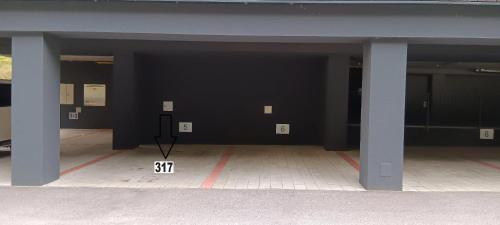 an empty parking garage with black walls and columns at Residence Vlčice in Pec pod Sněžkou